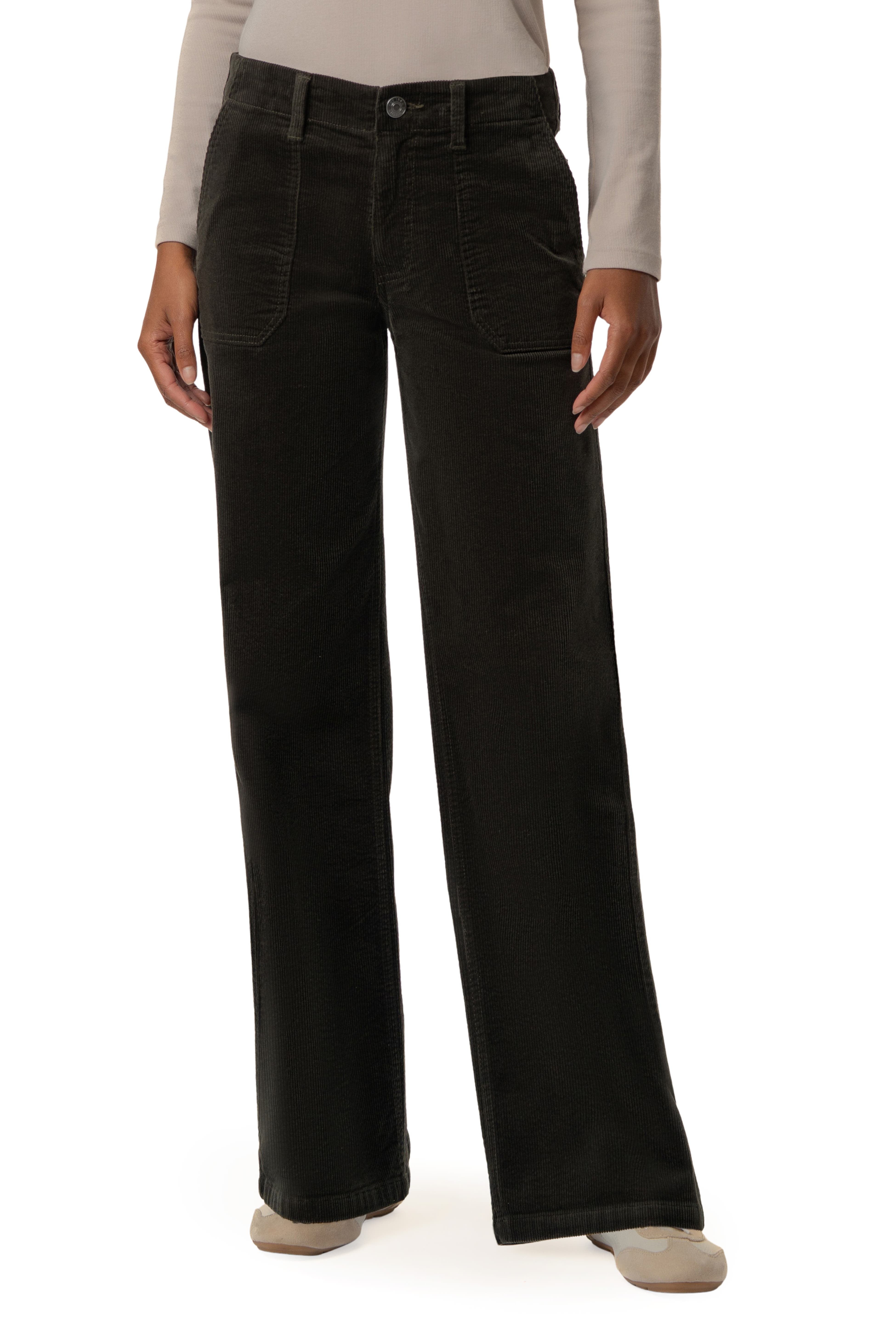 A person wearing dark green wide-leg corduroy pants with a beige long-sleeve top and beige shoes, shown from the waist down against a white background.